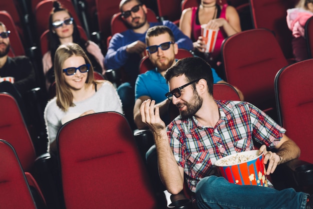 Man speaking with friends in cinema