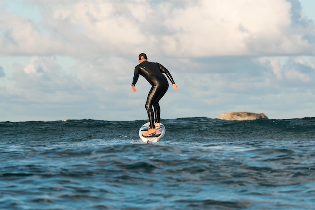 Free Photo man in special equipment surfing in hawaii