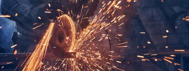 Man in special suit polishing metal with angle grinder