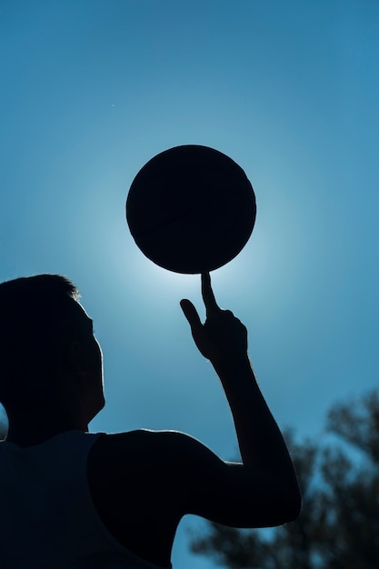 Man spinning basketball on finger