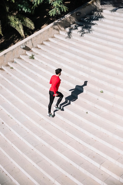 Free Photo man in sportswear running upstairs