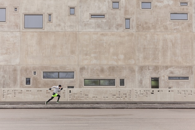 Free Photo man sprinting in urban environment