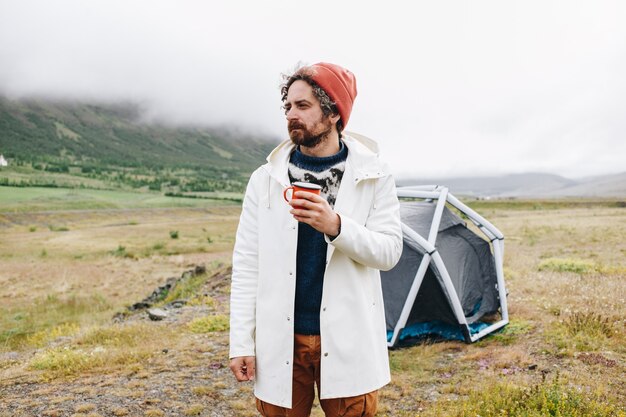 Man stand next to modern tent in iceland