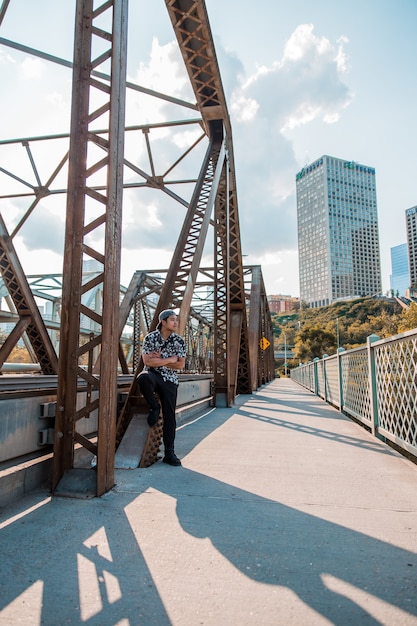 Man standing beside bridge