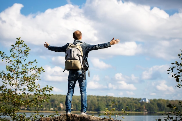 Man standing on a green grass in the mountain