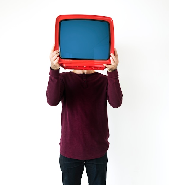 Free photo man standing and holding a tv