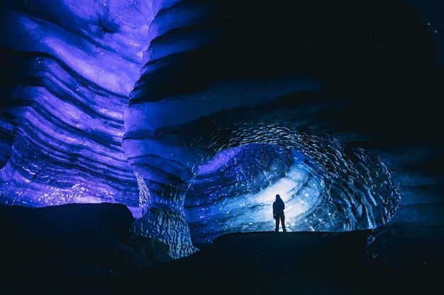 Free Photo man standing inside cave