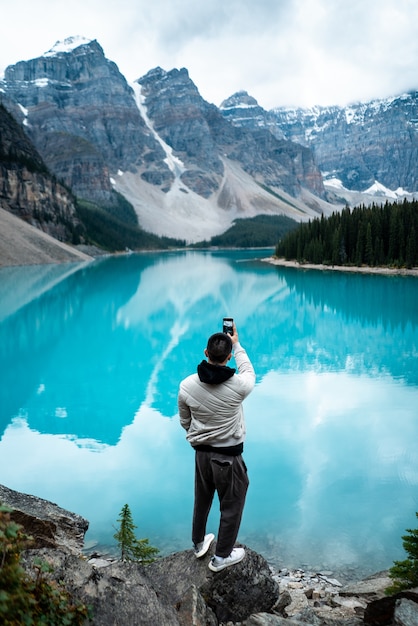 Man standing on Moraine Lake during daytime