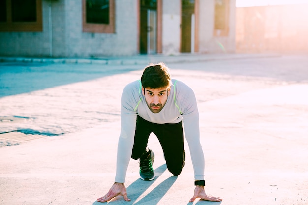 Man in start position looking at camera