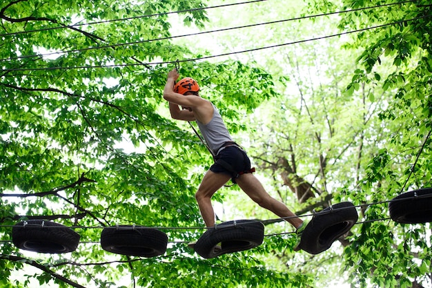 Man steps on the tyres hanging in the air