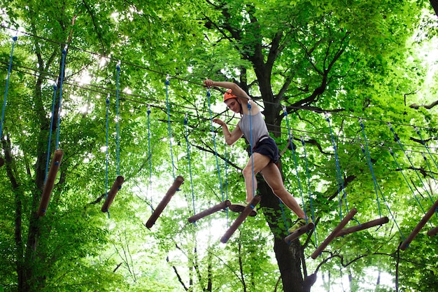 Man steps on the wooden blocks hanging in the air