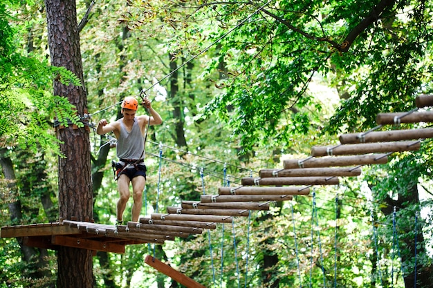 Man steps on the wooden blocks hanging in the air