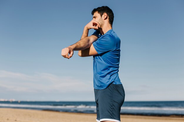 Man stretching at the beach