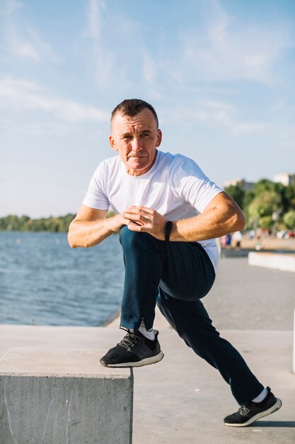 Man stretching his foot outdoors