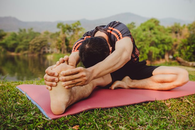 Man stretching next to the lake