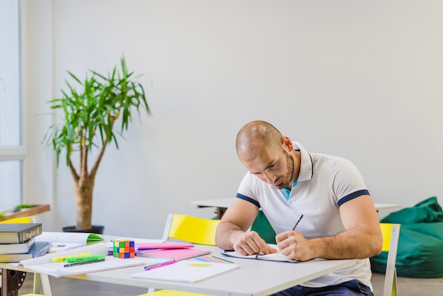 Man studying hard at table 