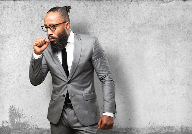 Man in suit coughing