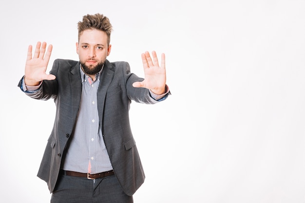 Man in suit gesturing stop