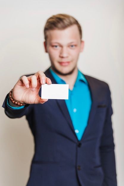 Free Photo man in suit holding visiting ca