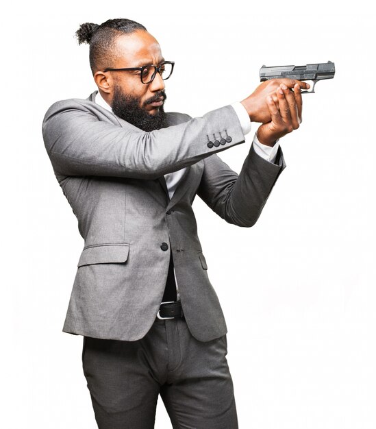 Man in suit pointing with a gun