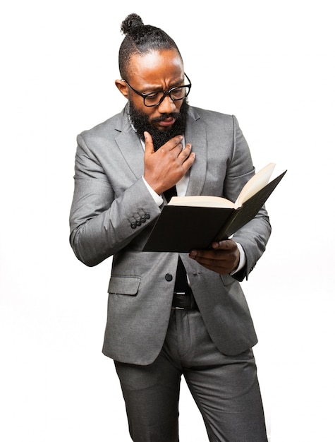 Man in suit reading a book