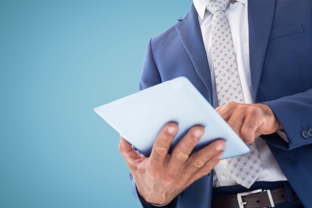 Man in suit and tie with a tablet