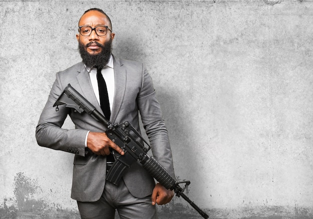 Man in suit with a machine gun