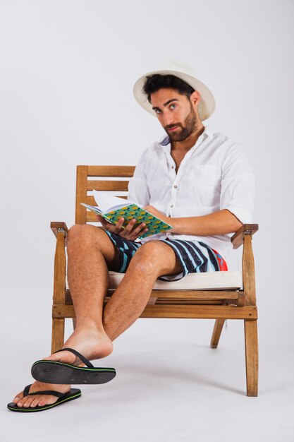 Man in summer wear reading