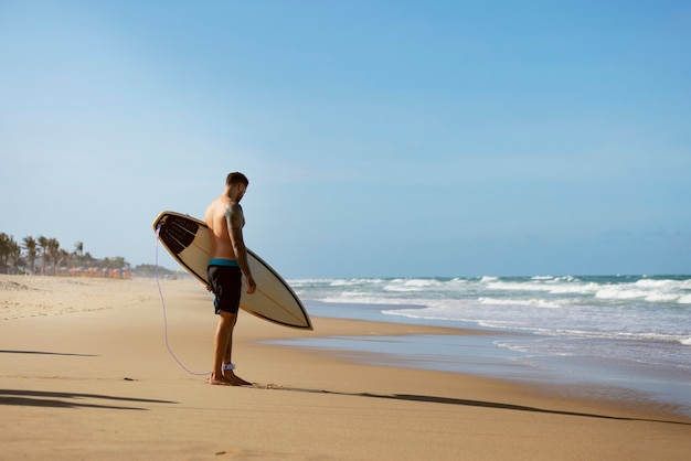 Free Photo man surfing in brazil