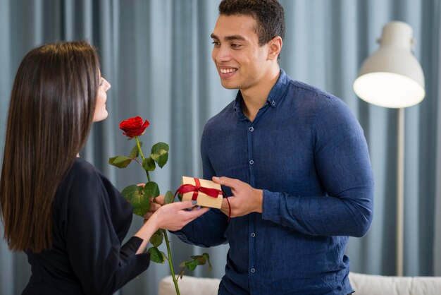 Man surprising his girlfriend with a cute gift