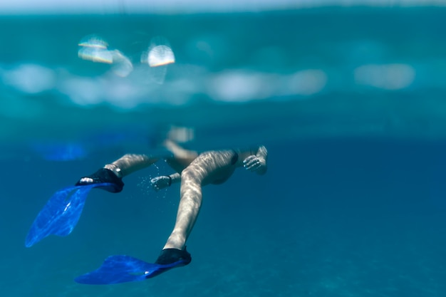 Free Photo man swimming under water