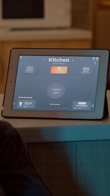 Free photo man switching on bulbs using voice command on tablet