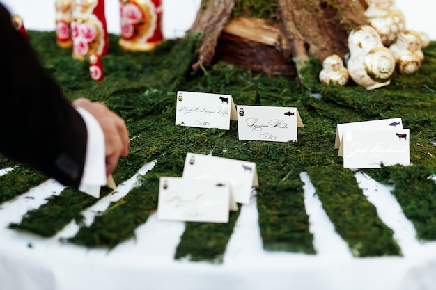 Free photo man takes card with guest name from the table