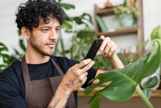 Man takes a photo of houseplant to share on social media