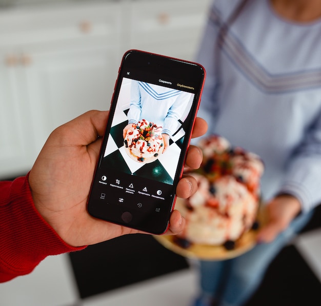 Man takes picture of cake on the phone