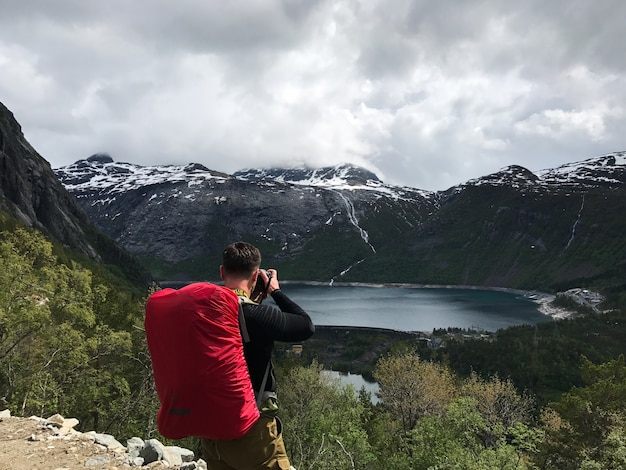 Man takes a picture of gorgeous Scandinavian landscape