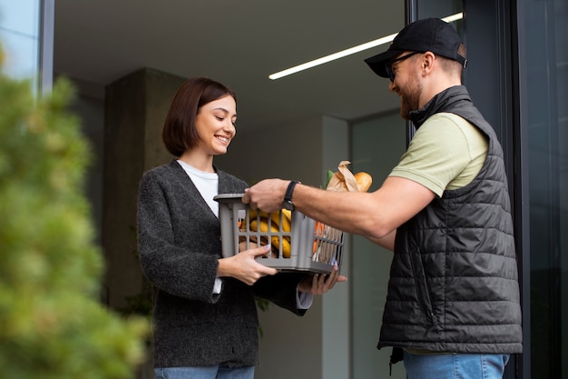 Free photo man taking care of home delivering groceries