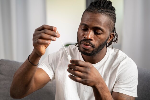 Man taking a covid test alone at home