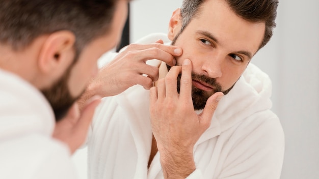 Man taking good care of his face at home