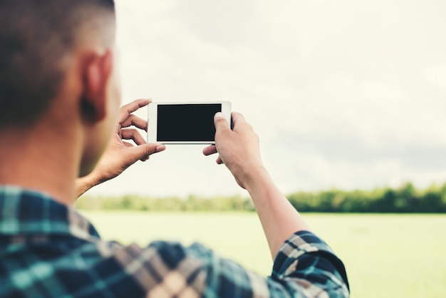 Free Photo man taking a photo with his phone