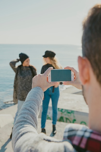 Man taking photo of women