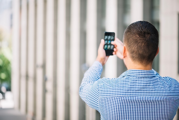 Free photo man taking photo