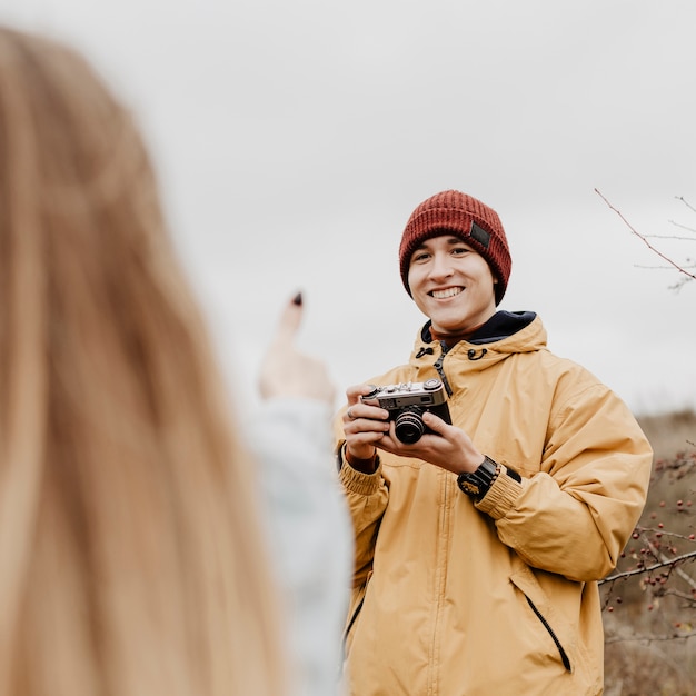 Man taking photos of his friends