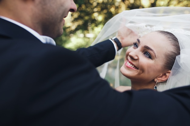 Free Photo man taking veil off bride