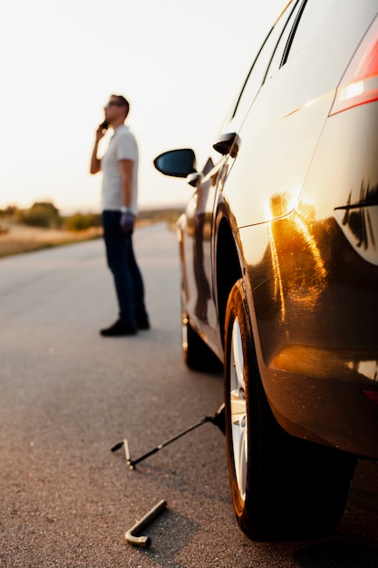 Man talking on the phone about a car problem