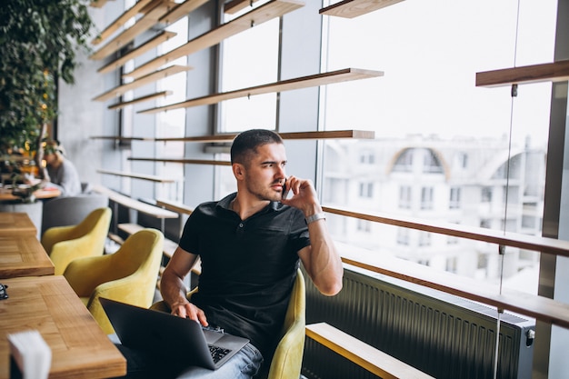 Man talking on the phone sitting in a cafe