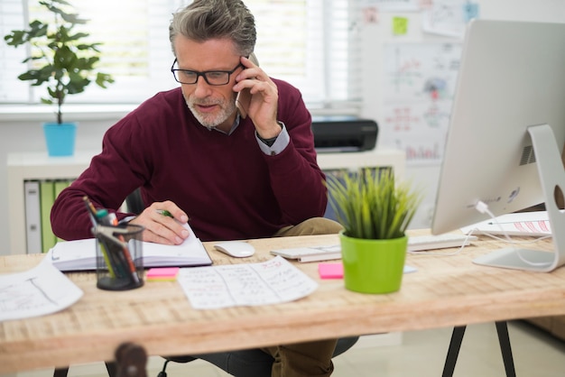 Man talking on the phone with one of his clients