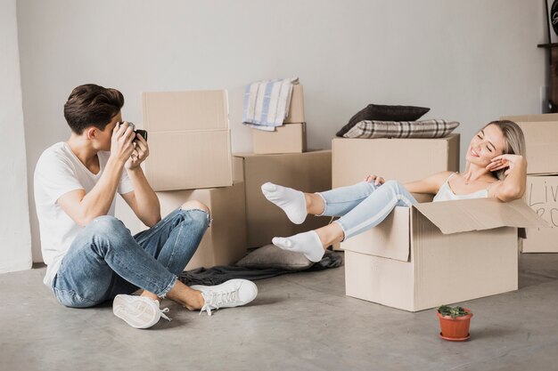 Man talking picture of woman in a box