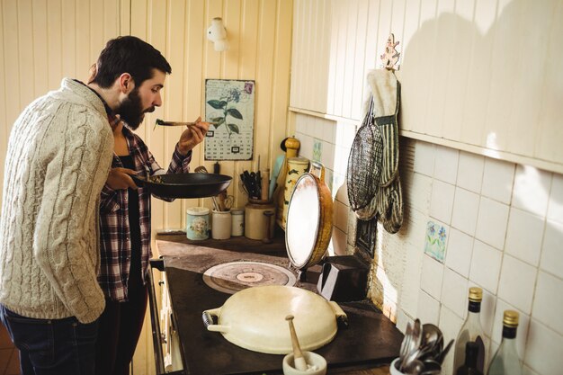 Man tasting food prepared by woman