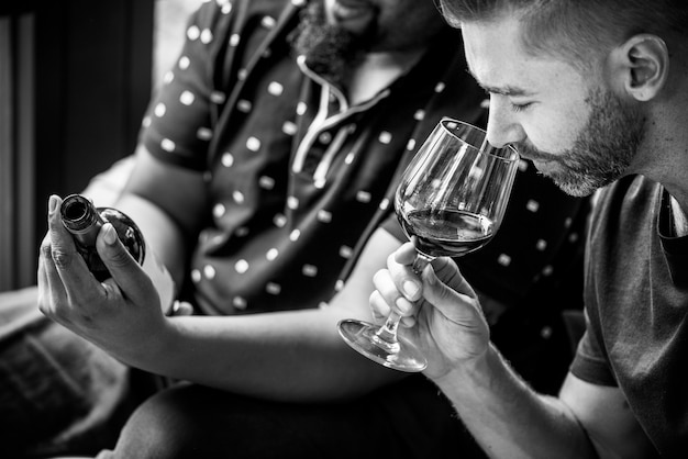 Man tasting red wine with friends